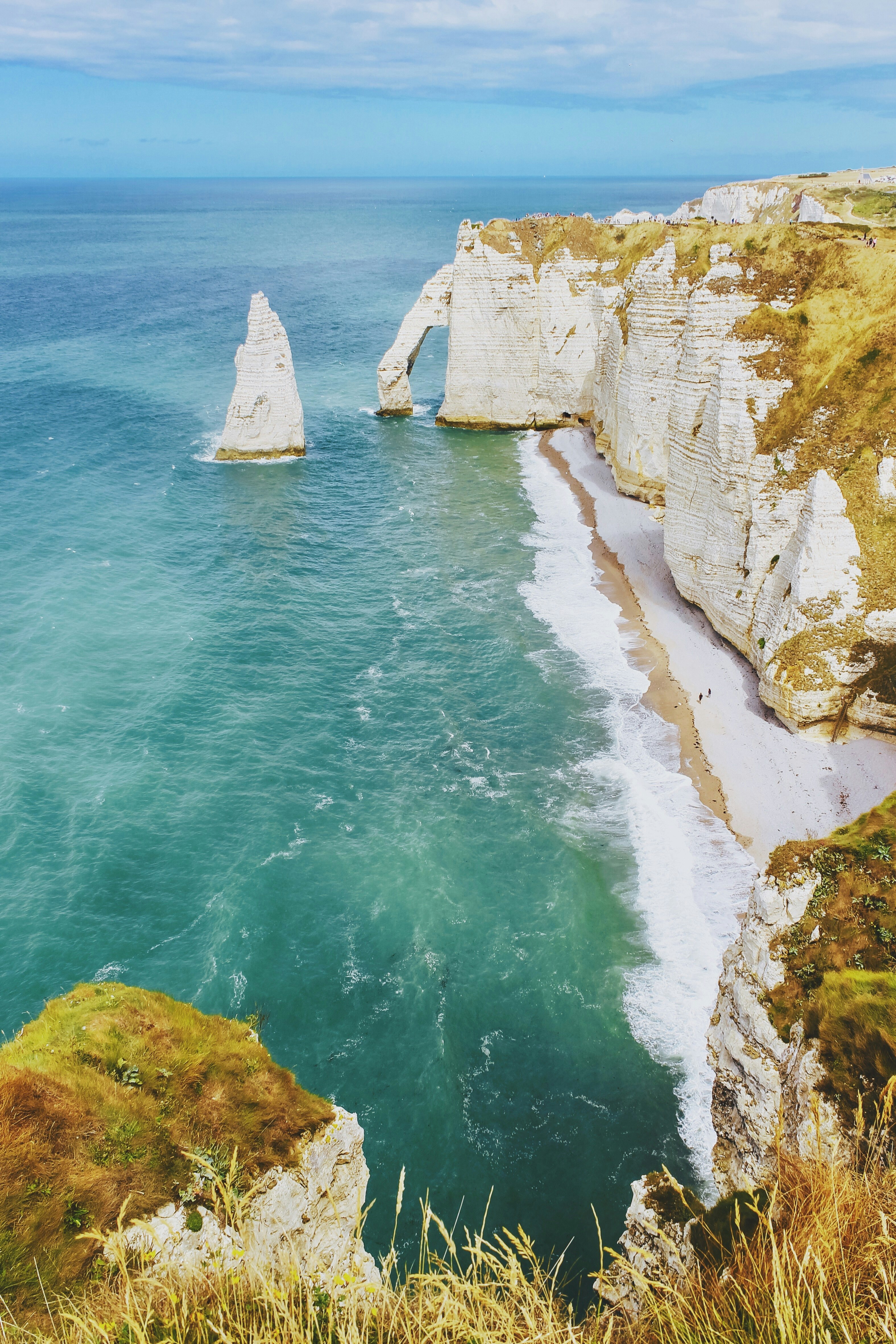 white cliff near body of water